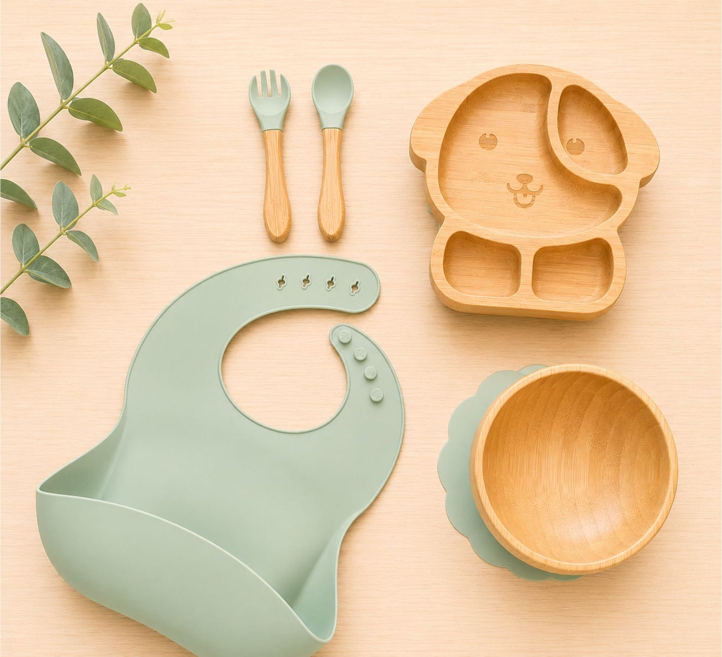 Cute Organic bamboo dog-shaped baby feeding set, eco-friendly, bpa free, silicone bib, suction bowl, and wooden spoon and fork in purple colour.