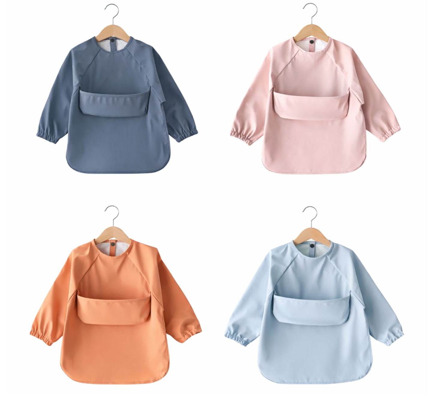 Four children's bibs in different colours (dark blue, light pink, orange and light blue) hanging on wooden hangers against a white background.