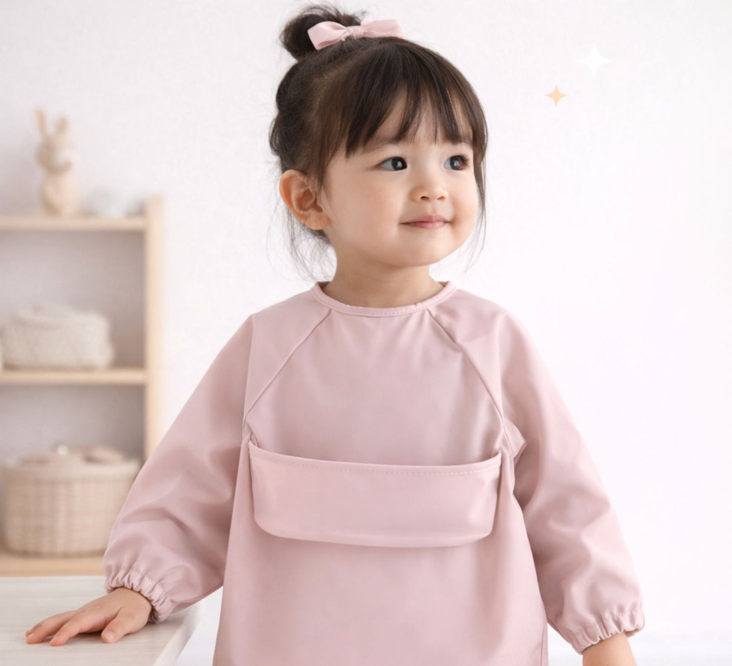 toddler girl wearing a pink feeding smock long sleeves