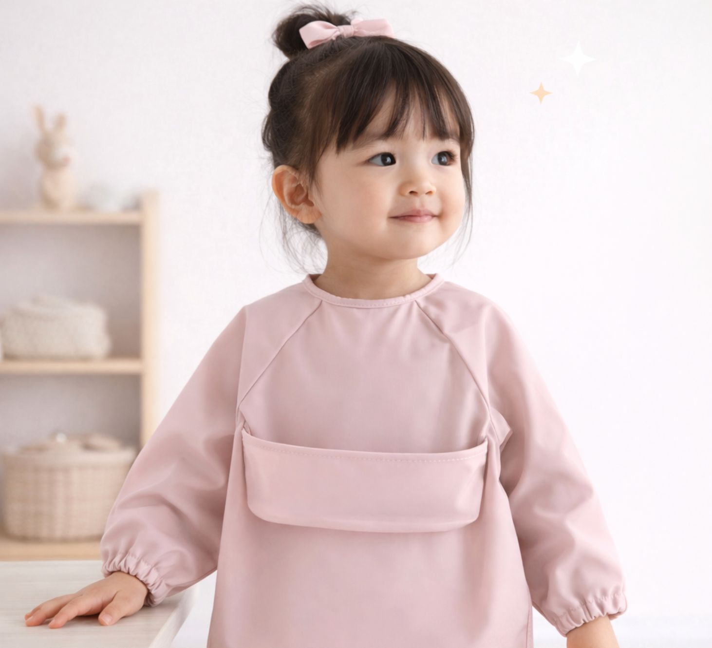 toddler girl wearing a pink feeding smock long sleeves