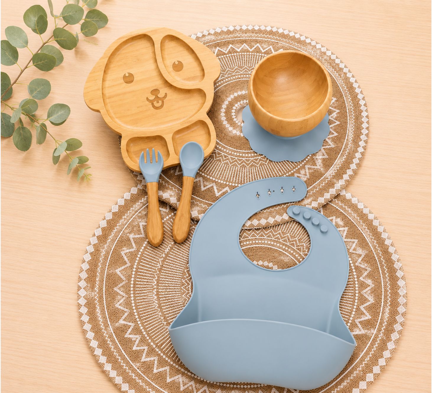 Organic bamboo dog-shaped baby feeding set, eco-friendly ,silicone bib, suction bowl, and wooden spoon and fork in blue colour.