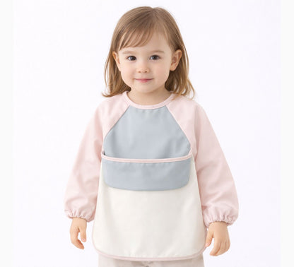toddler girl wearing a pink, white and gray long sleeve bib