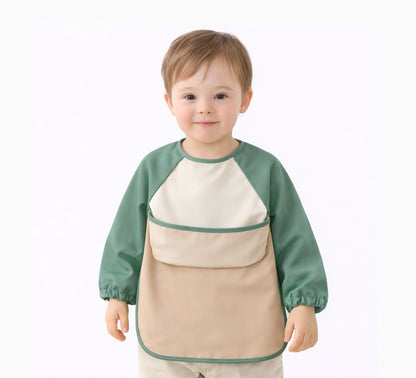 toddler boy wearing a green and beige waterproof long sleeve bib